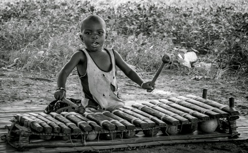 Child playing Balafon