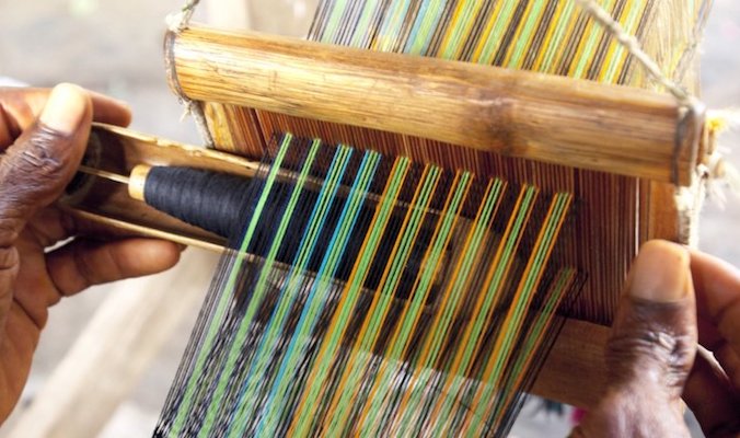 Using a traditional loom in eastern Ghana. JACOB SILBERBERG/GETTY IMAGES