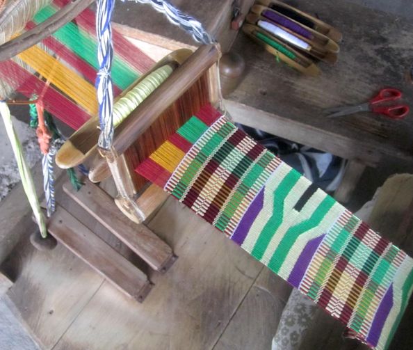 Kente cloth being woven on a traditional loom
